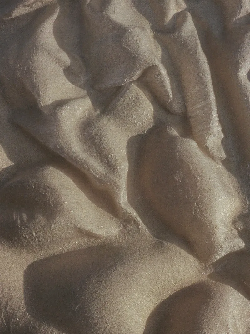 Sand-washed silk organza gathered into soft ridges like miniature dunes